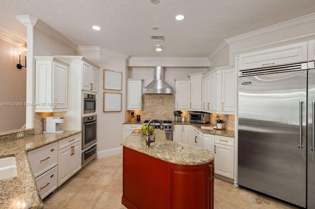 2211 Azalea Pl, Winter Park, FL 32789 - kitchen with premium appliances, wall chimney range hood, white cabinetry, decorative backsplash, and light stone counters