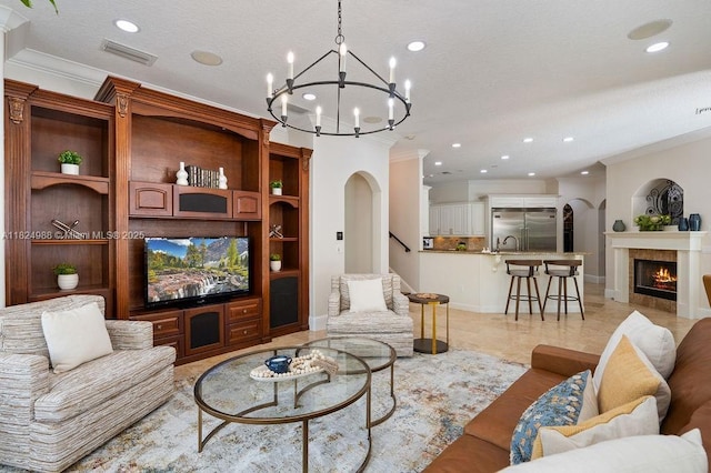 2211 Azalea Pl, Winter Park, FL 32789 - living room with a chandelier, crown molding, stairway, recessed lighting, and a fireplace