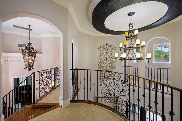 2211 Azalea Pl, Winter Park, FL 32789 - stairs featuring a chandelier, carpet flooring, arched walkways, and crown molding
