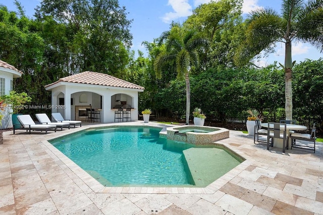 2211 Azalea Pl, Winter Park, FL 32789 - view of swimming pool featuring a patio area, a pool with connected hot tub, an exterior structure, and an outbuilding
