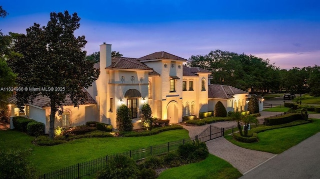 2211 Azalea Pl, Winter Park, FL 32789 - mediterranean / spanish-style home featuring decorative driveway, stucco siding, a gate, a chimney, and a tile roof