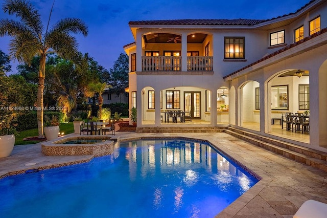 2211 Azalea Pl, Winter Park, FL 32789 - back of house at twilight featuring a balcony, a patio area, a tiled roof, and ceiling fan