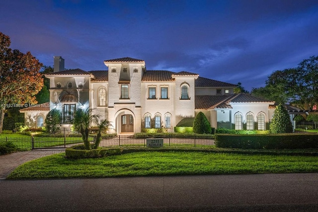 2211 Azalea Pl, Winter Park, FL 32789 - mediterranean / spanish-style house with a tile roof, a chimney, a fenced front yard, stucco siding, and decorative driveway