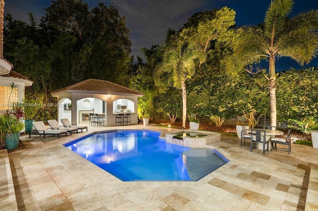2211 Azalea Pl, Winter Park, FL 32789 - pool at twilight featuring a patio and a pool with connected hot tub