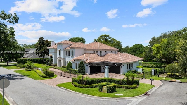 2211 Azalea Pl, Winter Park, FL 32789 - view of front facade featuring decorative driveway, an attached garage, stucco siding, a tiled roof, and a gate
