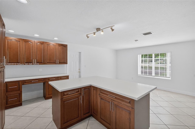 14861 SW 149th St, Miami, FL 33196 - kitchen with light countertops, a kitchen island, built in study area, light tile patterned flooring, and recessed lighting