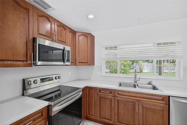 14861 SW 149th St, Miami, FL 33196 - kitchen with appliances with stainless steel finishes, light tile patterned flooring, light countertops, recessed lighting, and brown cabinetry