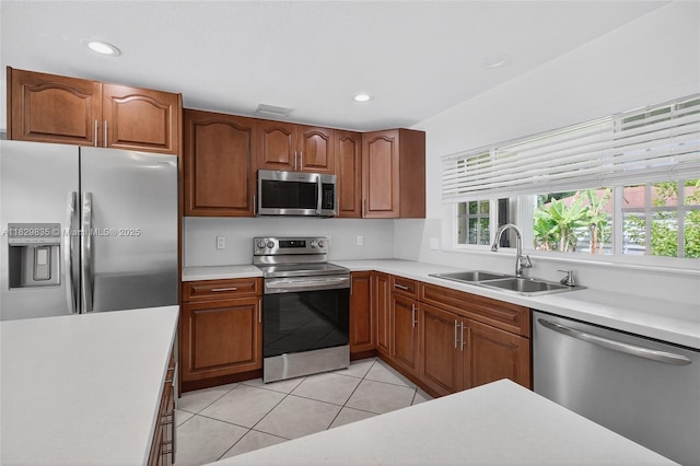 14861 SW 149th St, Miami, FL 33196 - kitchen with stainless steel appliances, light countertops, light tile patterned floors, recessed lighting, and brown cabinets