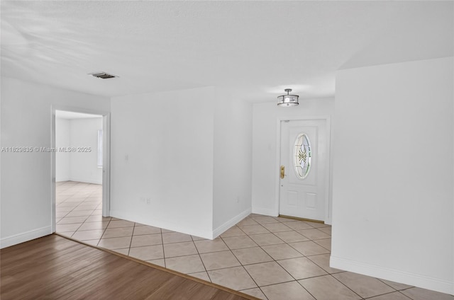14861 SW 149th St, Miami, FL 33196 - foyer featuring light tile patterned flooring and baseboards