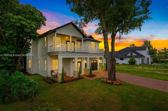 2607 Lafayette Ave, Winter Park, FL 32789 - view of front of house featuring a balcony, a lawn, and stucco siding