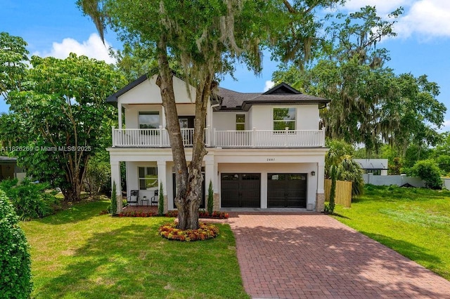 2607 Lafayette Ave, Winter Park, FL 32789 - view of front of property with a balcony, stucco siding, decorative driveway, and a garage