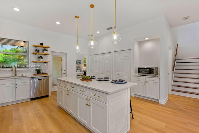 2607 Lafayette Ave, Winter Park, FL 32789 - kitchen with stainless steel appliances, light wood-style flooring, white cabinets, decorative backsplash, and recessed lighting