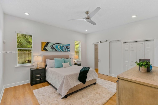 2607 Lafayette Ave, Winter Park, FL 32789 - bedroom with a barn door, light wood-style flooring, ceiling fan, recessed lighting, and a closet