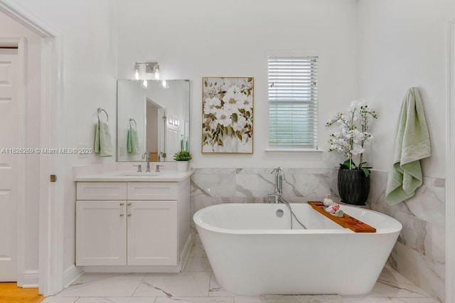 2607 Lafayette Ave, Winter Park, FL 32789 - full bathroom with marble finish flooring, vanity, a soaking tub, and tile walls