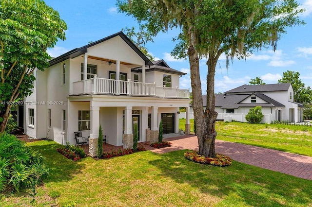 2607 Lafayette Ave, Winter Park, FL 32789 - view of front of home with a balcony, ceiling fan, stucco siding, a front yard, and decorative driveway