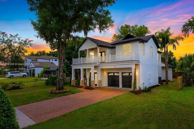 2607 Lafayette Ave, Winter Park, FL 32789 - view of front of home featuring a balcony, decorative driveway, a lawn, and stucco siding
