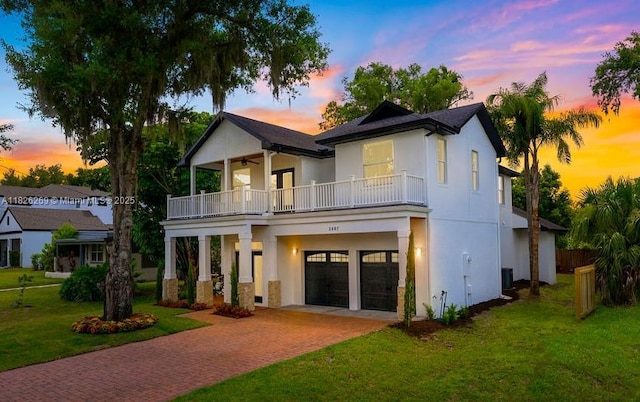 2607 Lafayette Ave, Winter Park, FL 32789 - view of front facade with a balcony, decorative driveway, a ceiling fan, stucco siding, and a garage