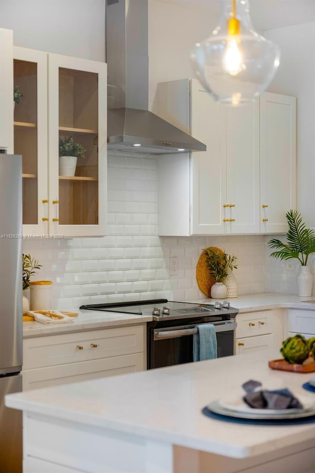 2607 Lafayette Ave, Winter Park, FL 32789 - kitchen with wall chimney exhaust hood, stainless steel appliances, white cabinets, and light countertops