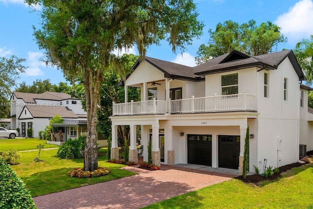 2607 Lafayette Ave, Winter Park, FL 32789 - view of front of property featuring a balcony, stucco siding, a front yard, and a garage