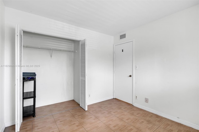 2106 S Cypress Bend Dr Unit 203, Pompano Beach, FL 33069 - unfurnished bedroom featuring a closet and light tile patterned floors