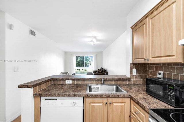 2106 S Cypress Bend Dr Unit 203, Pompano Beach, FL 33069 - kitchen with dishwasher, dark countertops, light brown cabinets, backsplash, and a peninsula