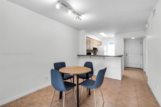 2106 S Cypress Bend Dr Unit 203, Pompano Beach, FL 33069 - dining space featuring track lighting and baseboards