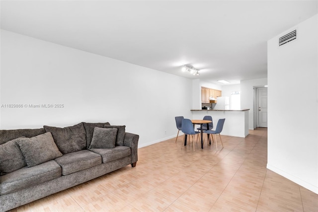 2106 S Cypress Bend Dr Unit 203, Pompano Beach, FL 33069 - living room featuring baseboards and track lighting