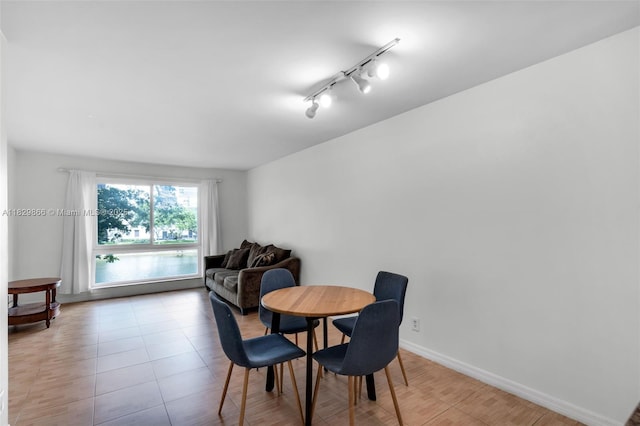 2106 S Cypress Bend Dr Unit 203, Pompano Beach, FL 33069 - dining area with track lighting and light wood-style floors