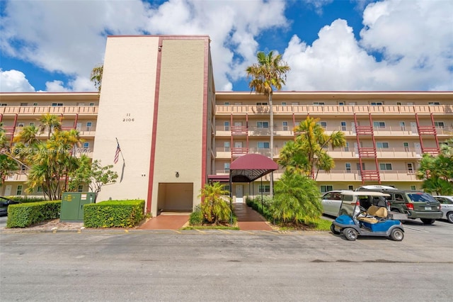 2106 S Cypress Bend Dr Unit 203, Pompano Beach, FL 33069 - view of apartment building / complex with uncovered parking