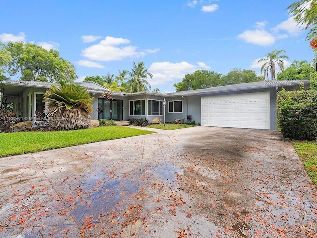 13530 SW 77th Ave, Pinecrest, FL 33156 - view of front of property featuring concrete driveway, an attached garage, stucco siding, and a front yard