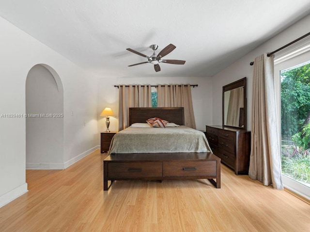 13530 SW 77th Ave, Pinecrest, FL 33156 - bedroom with light wood-style floors, arched walkways, and ceiling fan