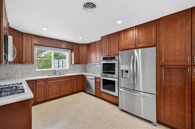 6201 SW 3rd St, Plantation, FL 33317 - kitchen with stainless steel appliances, tasteful backsplash, light countertops, recessed lighting, and brown cabinetry