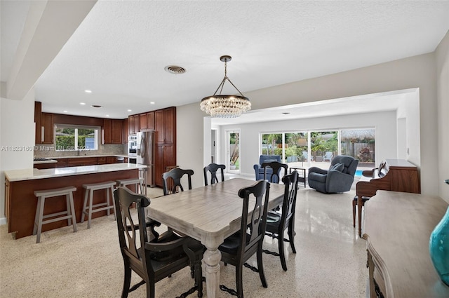 6201 SW 3rd St, Plantation, FL 33317 - dining room featuring dark speckled floor, a textured ceiling, recessed lighting, and a chandelier
