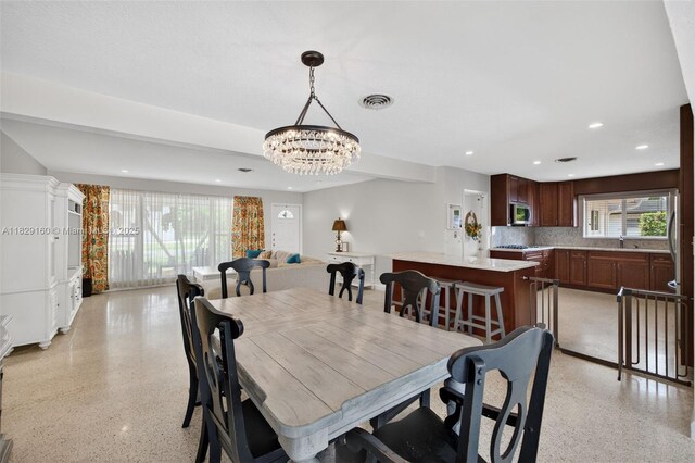 6201 SW 3rd St, Plantation, FL 33317 - dining space with dark aggregate flooring, a chandelier, and recessed lighting