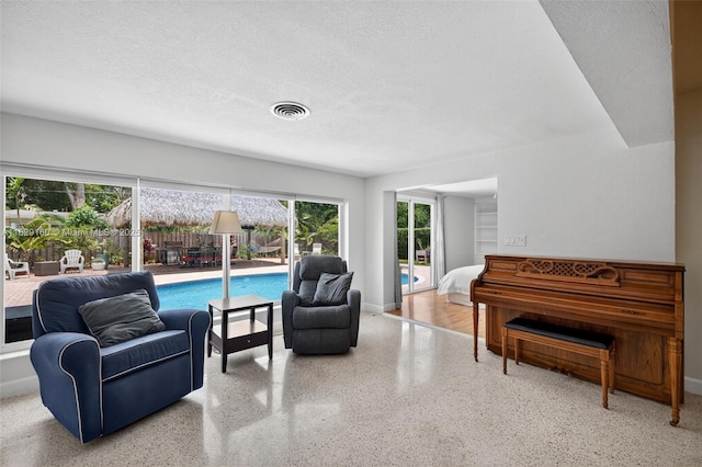 6201 SW 3rd St, Plantation, FL 33317 - living room featuring speckle patterned floor and a textured ceiling
