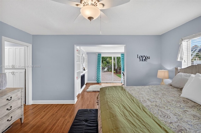 6201 SW 3rd St, Plantation, FL 33317 - bedroom with wood finished floors, a fireplace, access to outside, and a ceiling fan