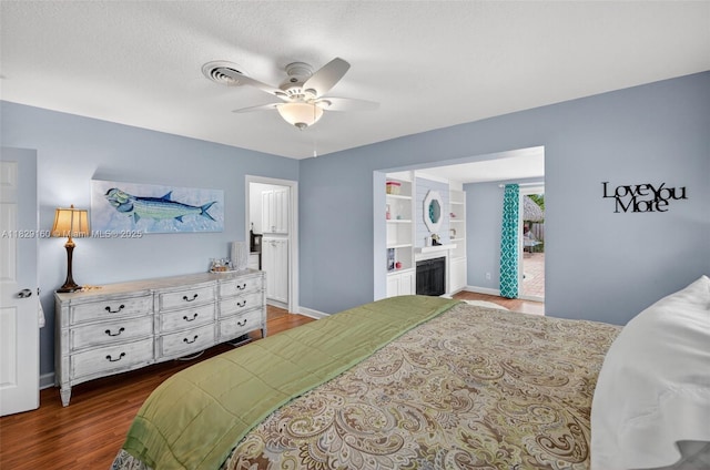 6201 SW 3rd St, Plantation, FL 33317 - bedroom featuring dark wood-type flooring, connected bathroom, a ceiling fan, and a fireplace