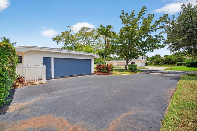 6201 SW 3rd St, Plantation, FL 33317 - view of front of property with stucco siding and asphalt driveway