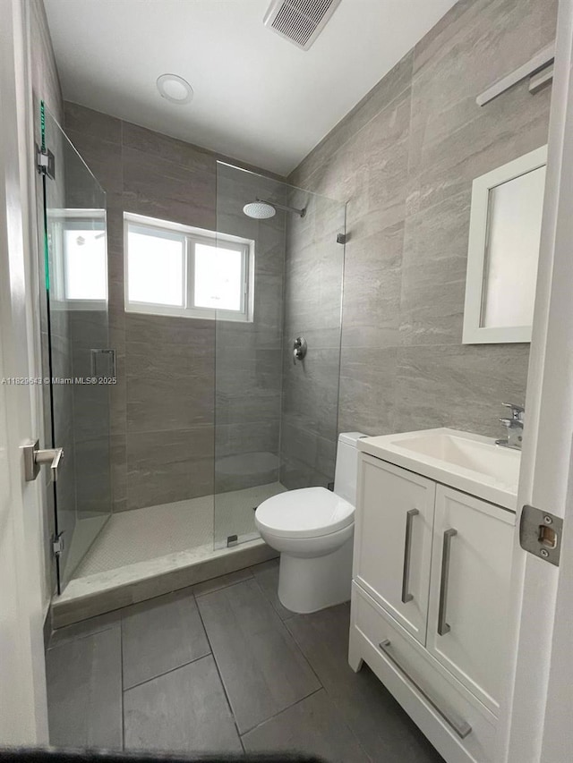 1401 NE 178th St, North Miami Beach, FL 33162 - full bath featuring a shower stall, tile walls, vanity, and tile patterned floors