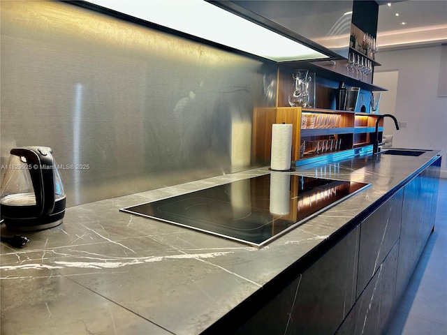 2301 Collins Ave Unit 1634/1635, Miami Beach, FL 33139 - kitchen view of black electric stovetop, open shelves, and modern cabinets