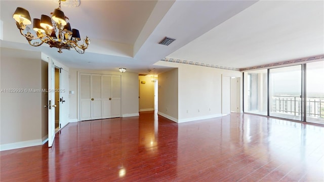 11113 Biscayne Blvd Unit 2056, Miami, FL 33181 - unfurnished room featuring wood finished floors, a chandelier, and expansive windows