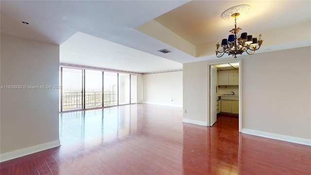 11113 Biscayne Blvd Unit 2056, Miami, FL 33181 - spare room with a chandelier and wood finished floors