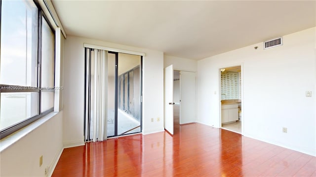 11113 Biscayne Blvd Unit 2056, Miami, FL 33181 - unfurnished bedroom featuring wood finished floors, a closet, and ensuite bathroom
