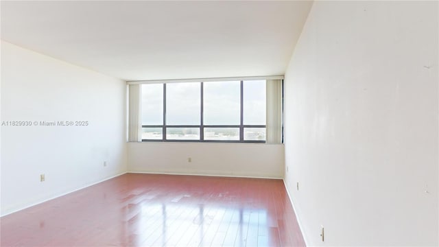 11113 Biscayne Blvd Unit 2056, Miami, FL 33181 - spare room featuring wood finished floors and baseboards