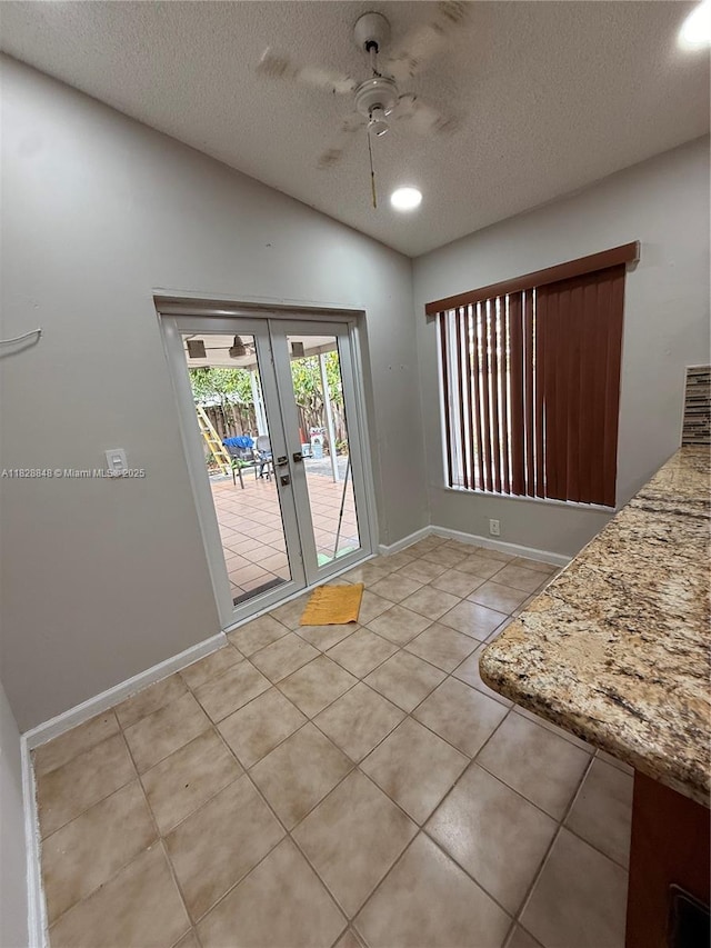 19926 NW 67th Pl, Hialeah, FL 33015 - unfurnished dining area featuring ceiling fan, a textured ceiling, french doors, light tile patterned flooring, and lofted ceiling