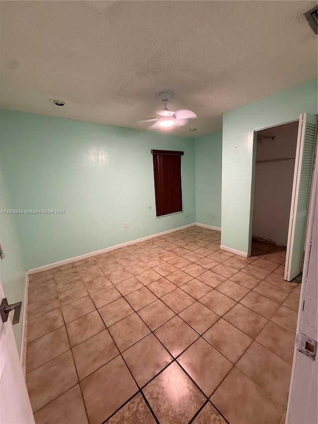 19926 NW 67th Pl, Hialeah, FL 33015 - unfurnished room featuring light tile patterned flooring, a ceiling fan, and a textured ceiling