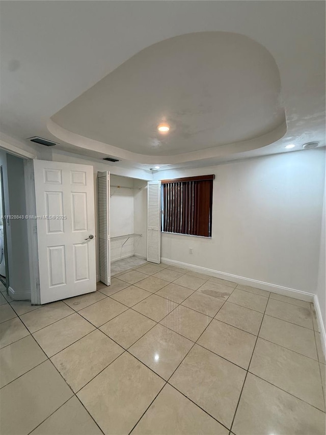 19926 NW 67th Pl, Hialeah, FL 33015 - spare room with a raised ceiling, light tile patterned flooring, and recessed lighting