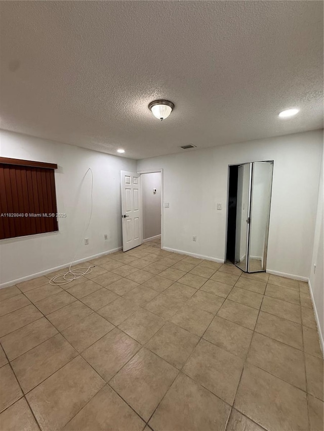 19926 NW 67th Pl, Hialeah, FL 33015 - spare room with a textured ceiling, light tile patterned floors, and recessed lighting