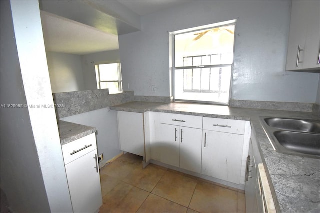 4231 NW 19th St Unit 256, Lauderhill, FL 33313 - kitchen with white cabinetry and light tile patterned floors