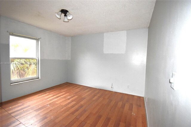 4231 NW 19th St Unit 256, Lauderhill, FL 33313 - unfurnished room with hardwood / wood-style floors and a textured ceiling
